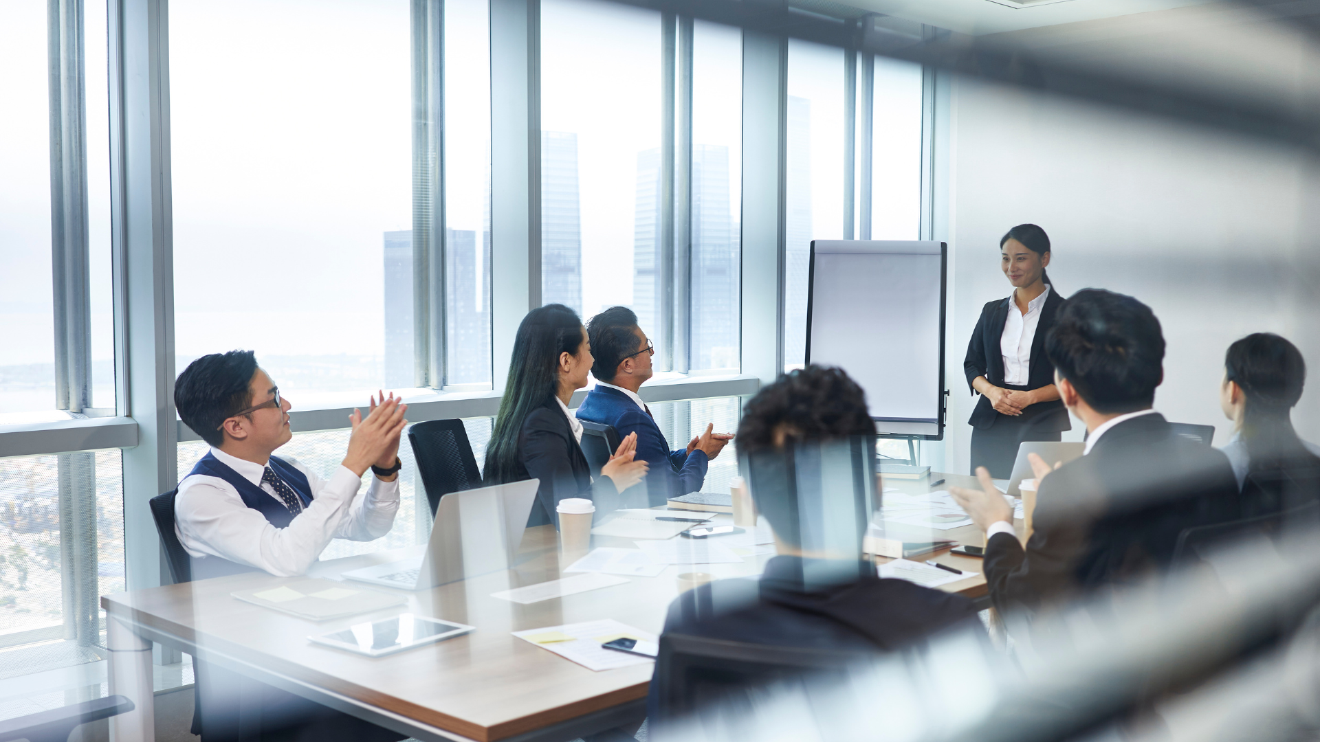 Professional business meeting in modern office with city view